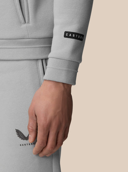 Close-up of a grey Adapt Fleece Zip-Through Hoodie sleeve showing the cuff and Castore badge.