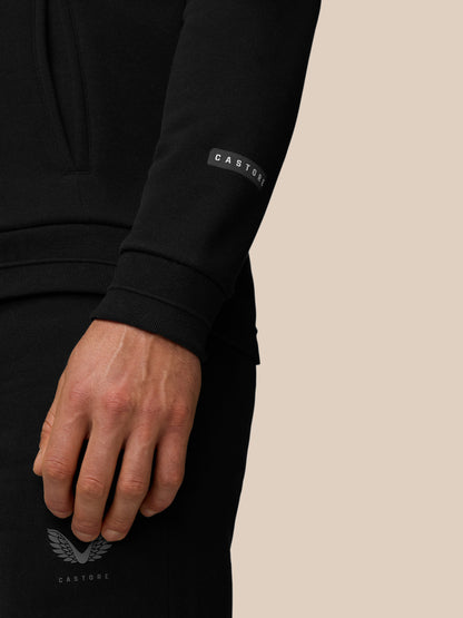 Close-up of a black Adapt Fleece Zip-Through Hoodie sleeve with a Castore logo patch at the cuff