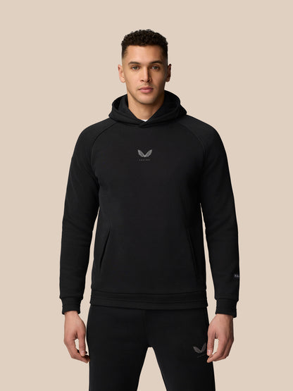 Model wearing black Adapt Fleece Hoodie with hood up, front pocket and chest logo.