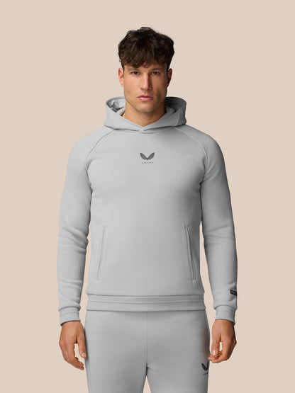 Male model in light grey Adapt Fleece Hoodie with hood and front pockets