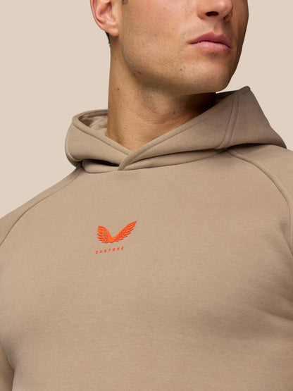 Close-up of Adapt Fleece Hoodie in Clay showing hood neckline and orange chest logo