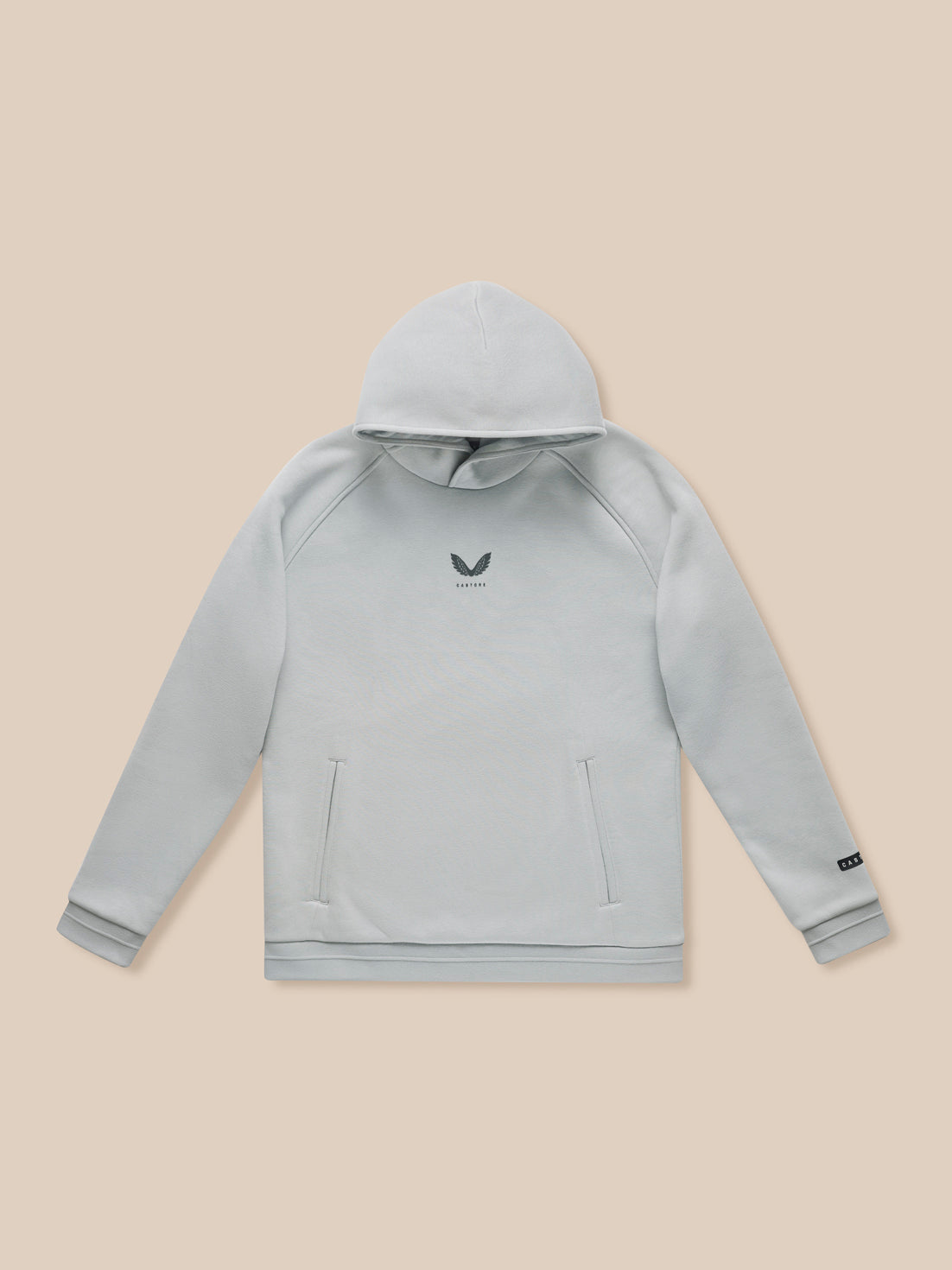 Adapt Fleece Hoodie in grey with front pockets and small logo on beige backdrop