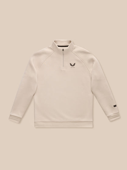 Adapt Fleece Quarter Zip in stone with a stand collar and small chest logo on beige fabric