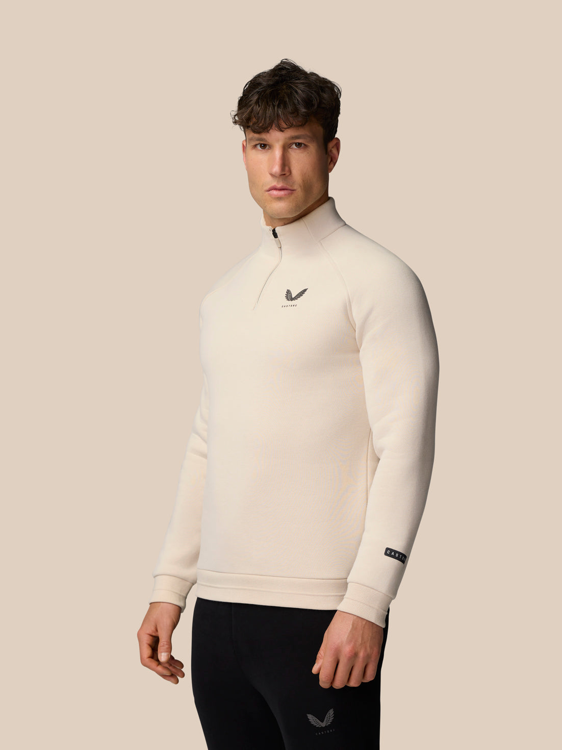 Male model wearing Adapt Fleece Quarter Zip Stone Gunmetal with front zip and chest logo