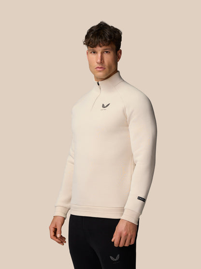 Male model wearing Adapt Fleece Quarter Zip Stone Gunmetal with front zip and chest logo