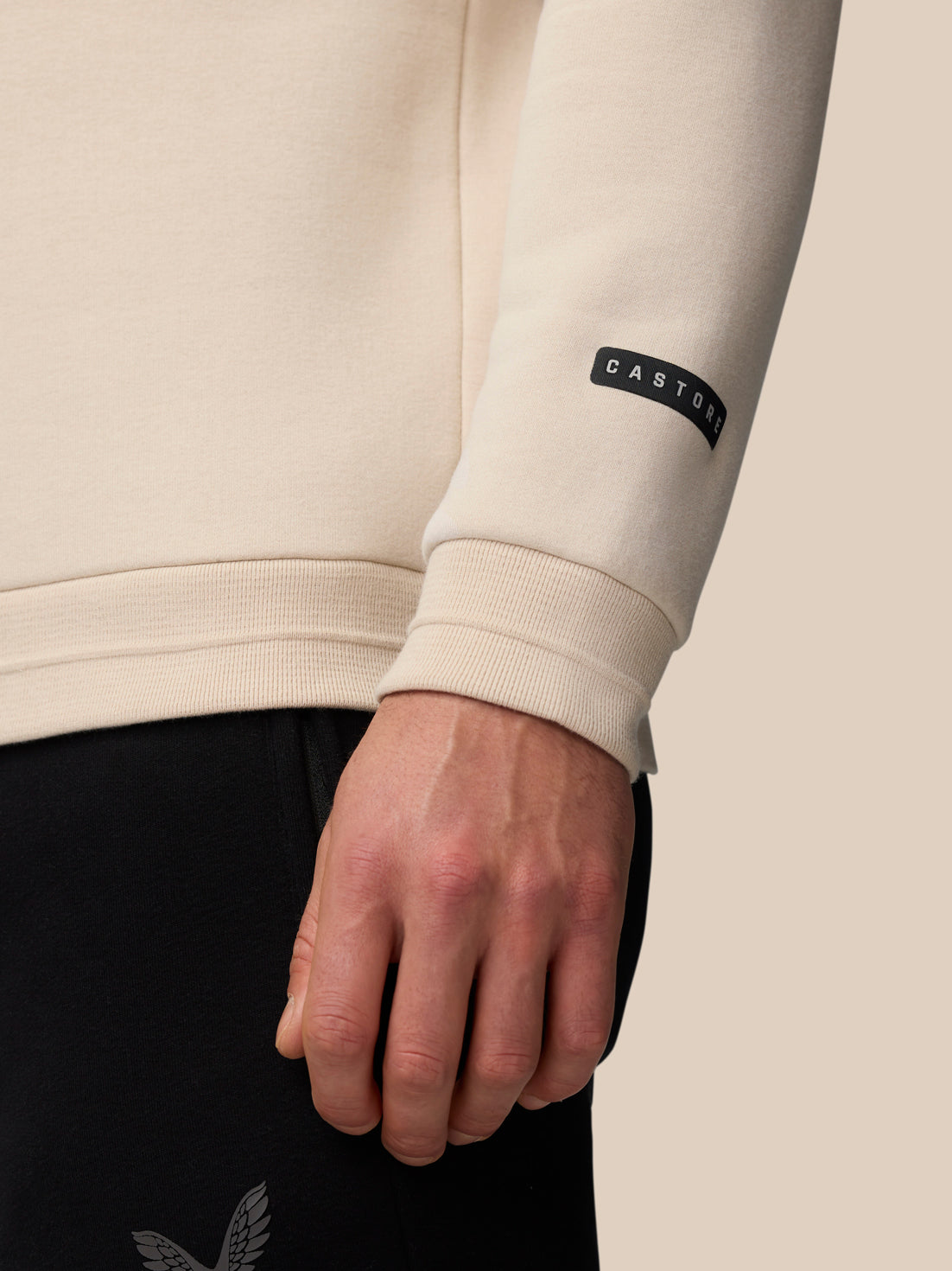 Close up of sleeve cuff on Adapt Fleece Quarter Zip Stone/Gunmetal showing Castore patch