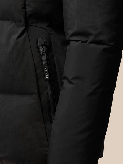 Close-up of front zipper and Castore branded zipper pull on a black puffer jacket.