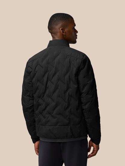 Back view of black padded jacket on male model showing quilted pattern and standing collar