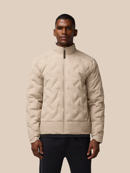 Man wearing mushroom colored padded jacket with zip front and high collar