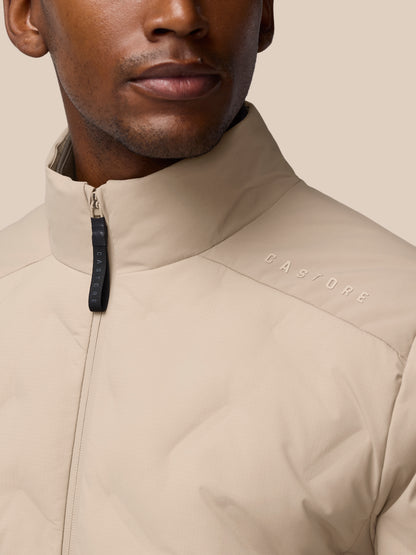 Beige Mushroom padded jacket close-up with front zipper and Castore branding.