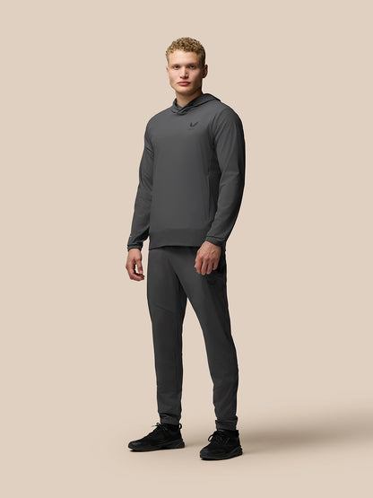 Male model wearing grey Lightweight Flex Hoodie with matching joggers and chest logo