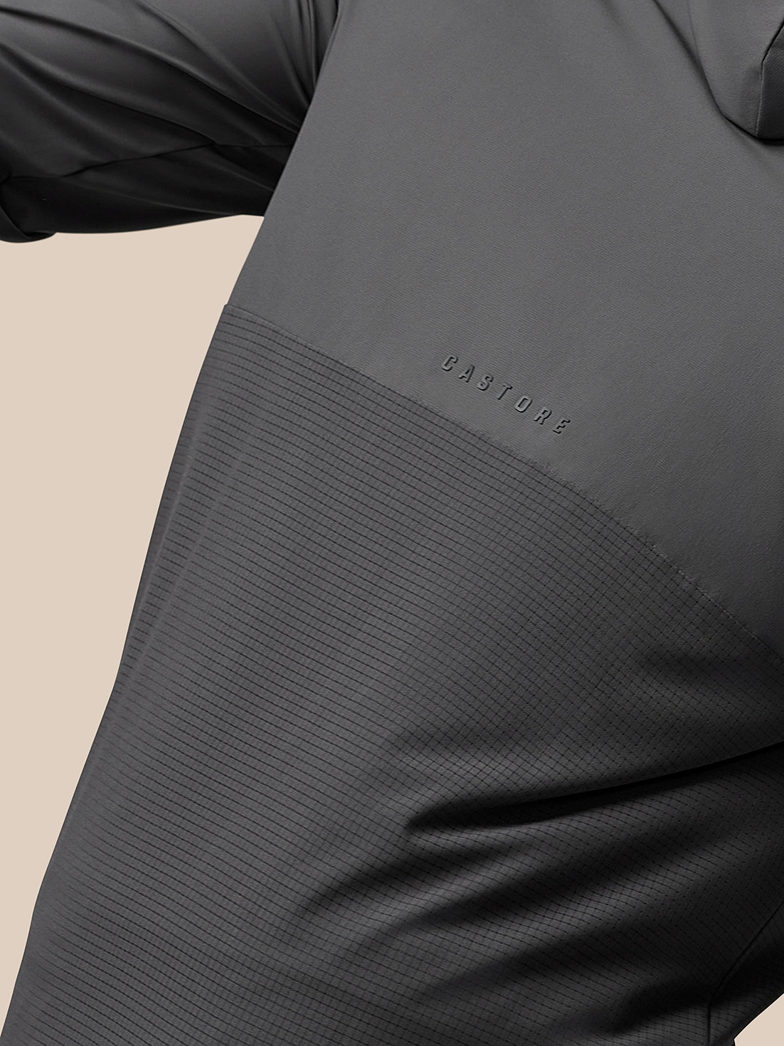 Close up of textured grey fabric panel with Castore branding embossed