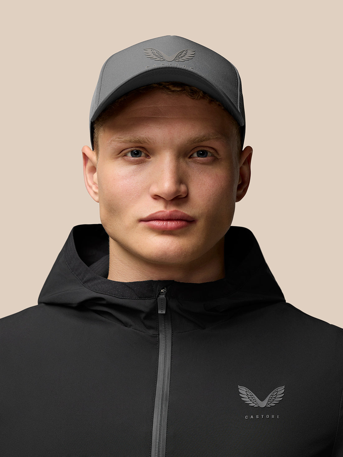 Male model wearing black Flex Lifestyle Jacket with hood and left chest logo
