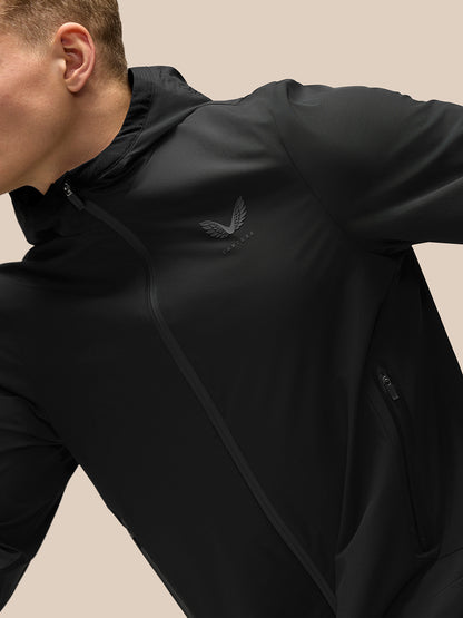 Model in black hooded Flex Lifestyle Jacket with left chest logo and front zip