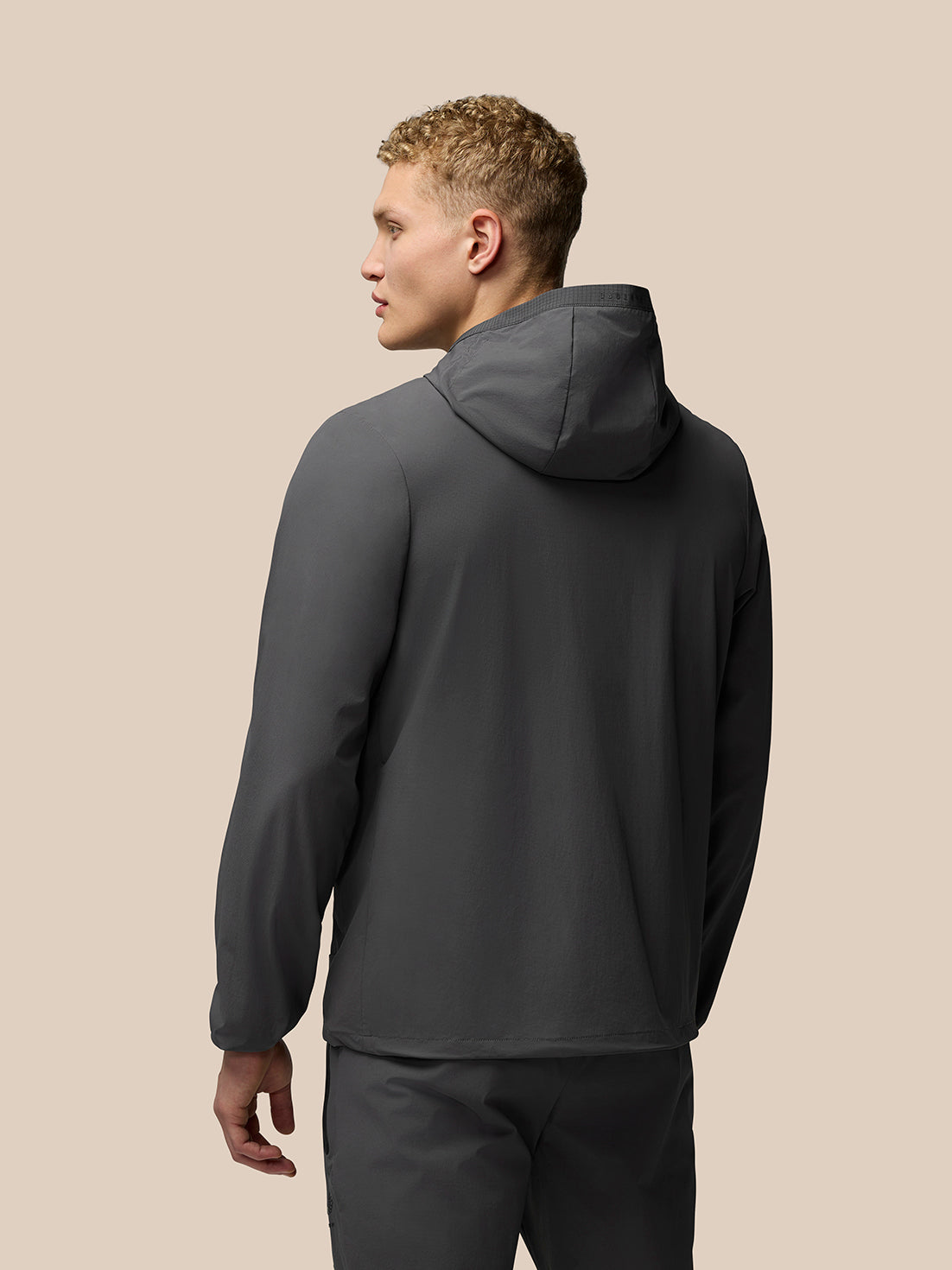 Charcoal Lightweight Flex Jacket worn by a male model shown from back with hood