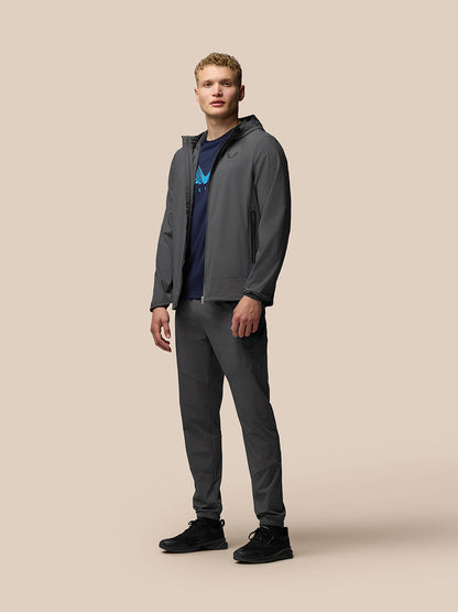 Male model wearing gunmetal Flex Classic Lifestyle Jacket with hood, front zipper, zip pockets and elastic cuffs.