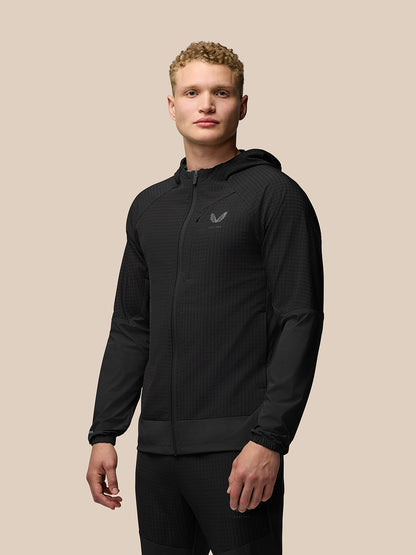 Model wearing black Flex Winterised Jacket with hood, front zip and raglan sleeves, logo on left chest.