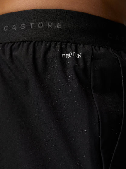 Close-up of ProTek logo on the back waistband of black Adapt Training Joggers with water droplets on fabric
