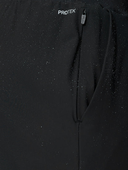 Close-up of black Adapt Tech Training Trousers with a zippered pocket and water droplets on fabric