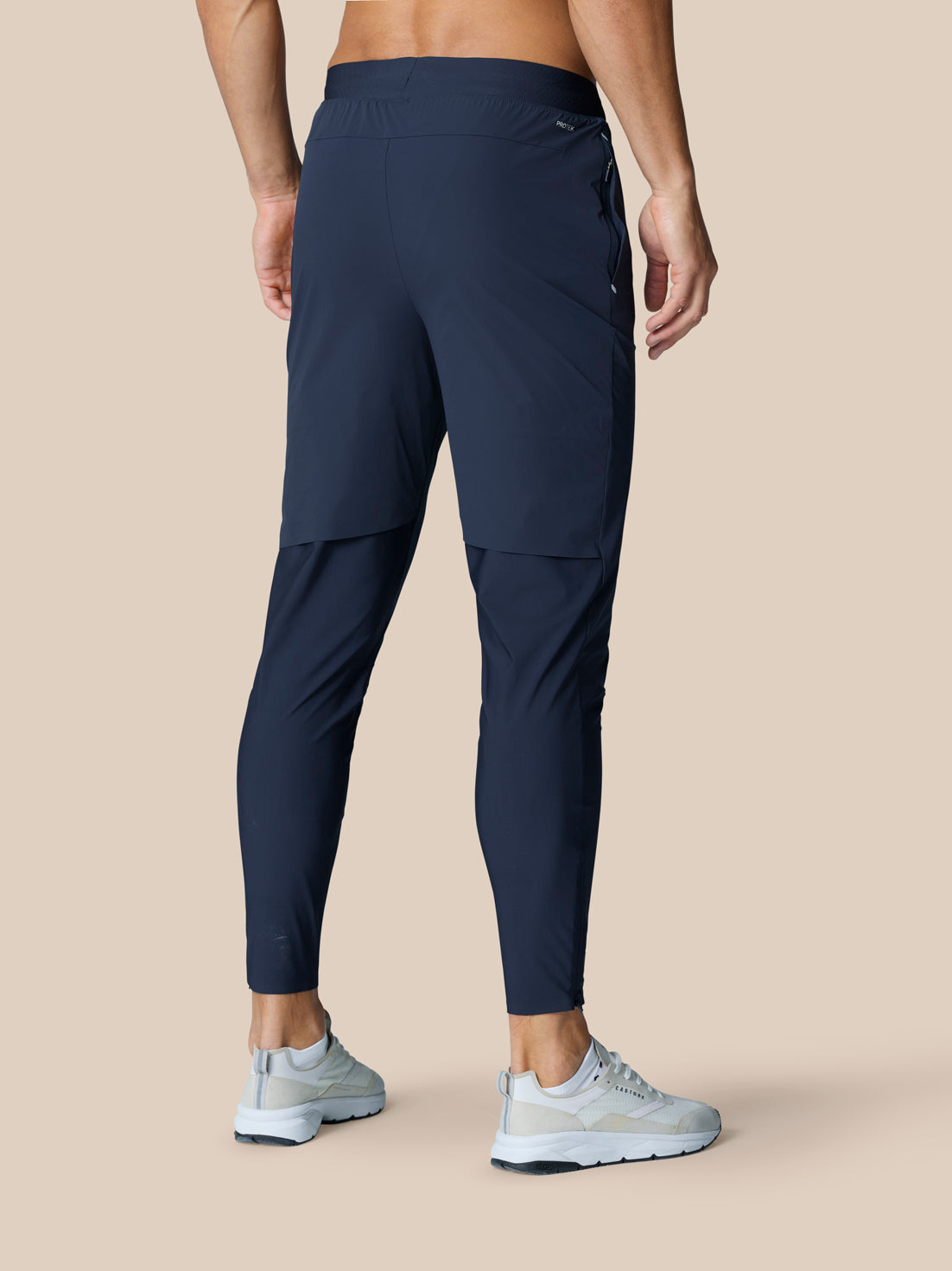 Back view of Zone Training Trousers Midnight Navy showing concealed zip pocket and ventilated back leg panel