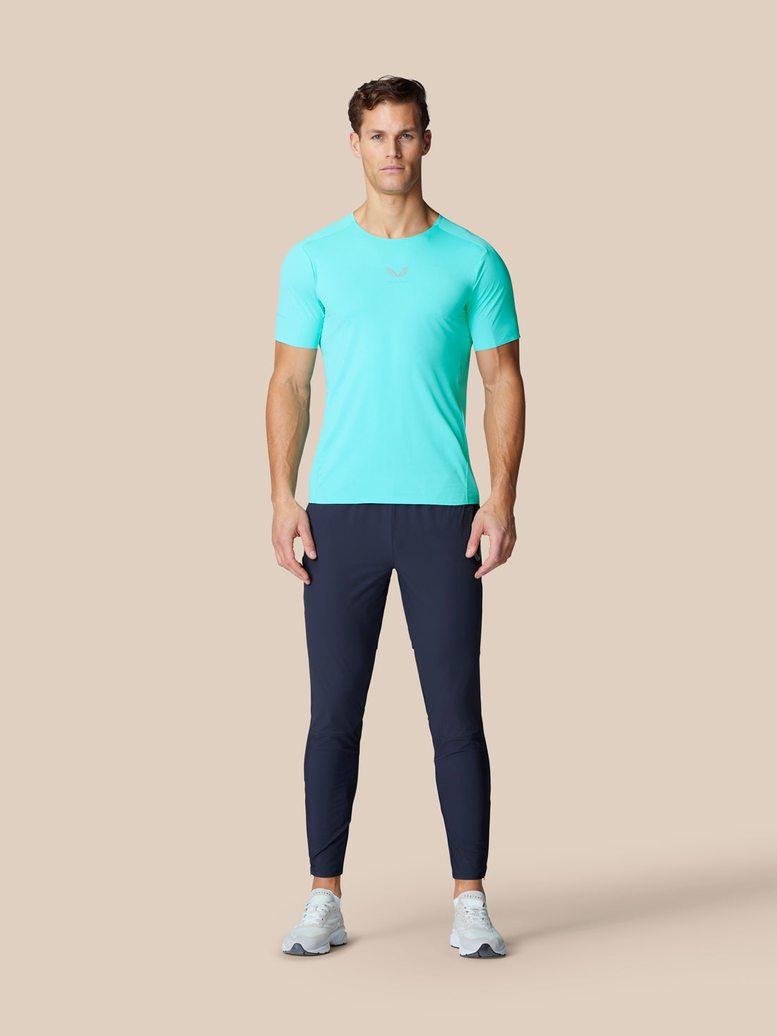 Model wearing Zone Training Trousers in midnight navy with a bright aqua tee