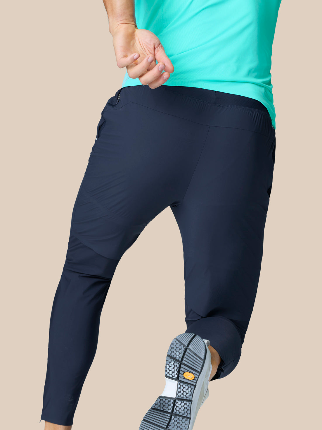 Rear view of Zone Training Trousers in Midnight Navy showing tapered fit and smooth back panels.