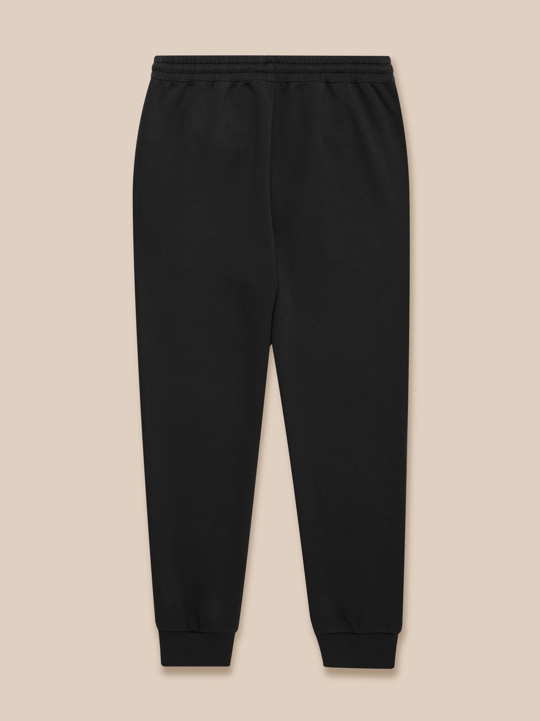 Flat lay of black Travel Lifestyle Joggers with zip pockets drawcord waistband and Castore logo