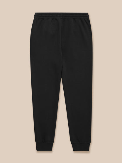 Flat lay of black Travel Lifestyle Joggers with zip pockets drawcord waistband and Castore logo