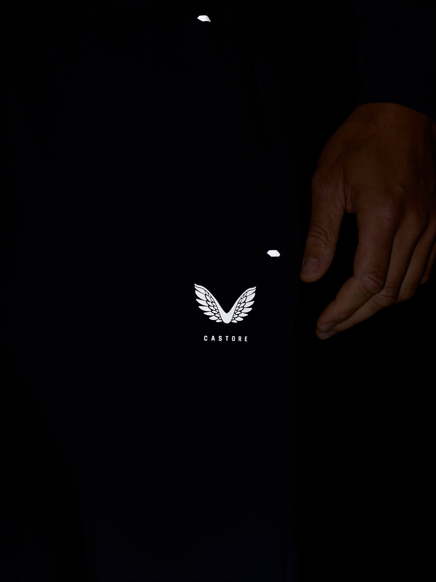 Close up of navy joggers featuring the white Castore logo wing on the thigh.