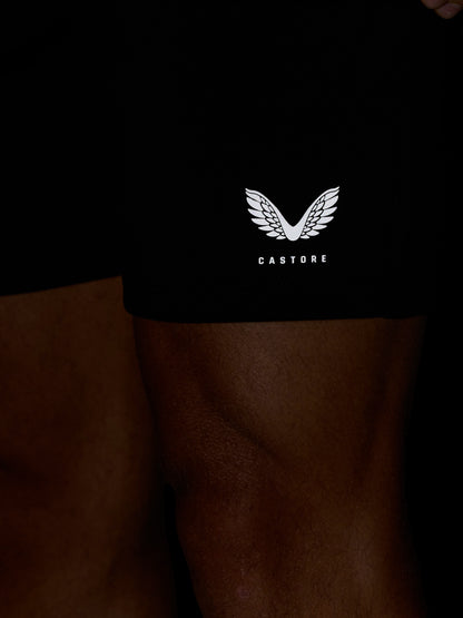 Close-up of black Travel Lifestyle Shorts with a white Castore wing logo near the hem