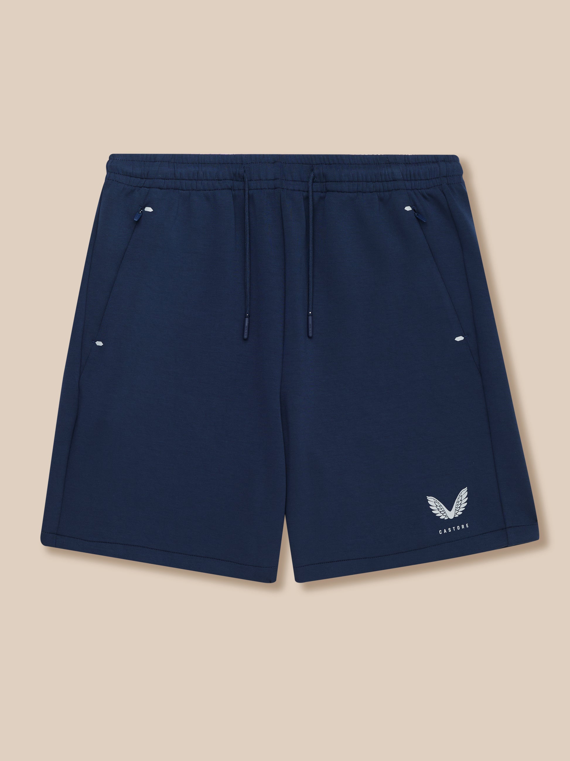 Navy Travel Lifestyle Shorts with drawcord waistband concealed zip pockets and Castore logo at bottom right.