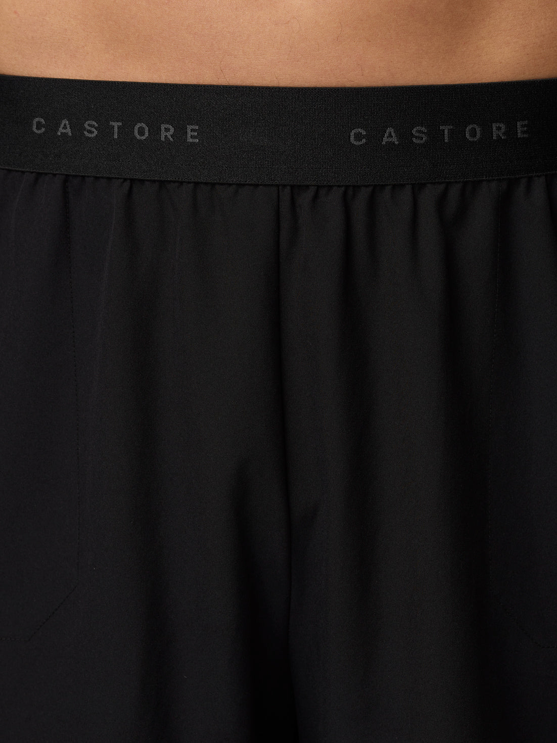 Back view of black Adapt Training Shorts waistband with Castore branding along the elastic.