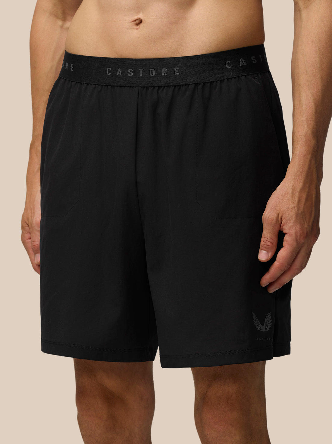 Model wearing black Adapt Training Shorts with a branded CASTORE waistband and small logo on the leg