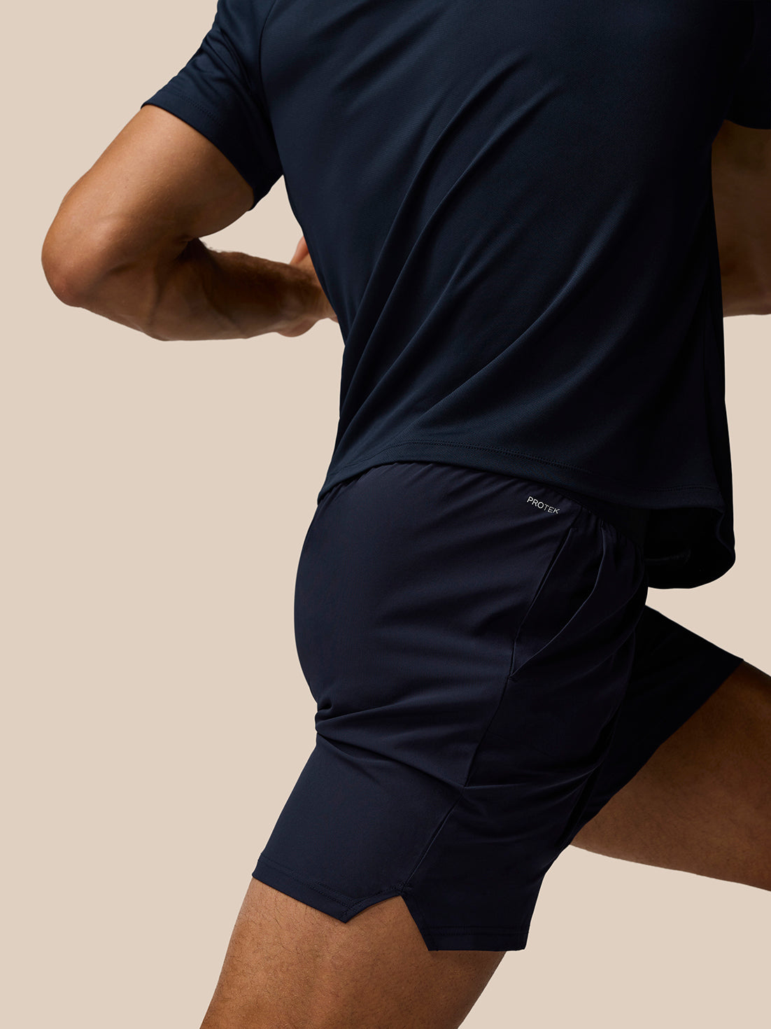 Close-up of navy Adapt Training Shorts showing Protek label at the back waistband