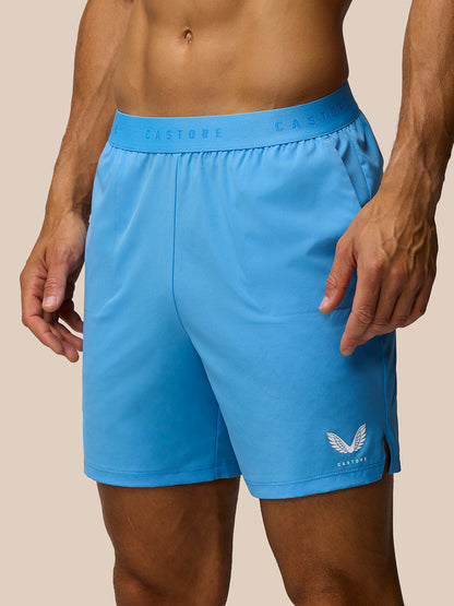 Front view of a man wearing bright blue Adapt Training Shorts with Castore branding on the waistband and left leg