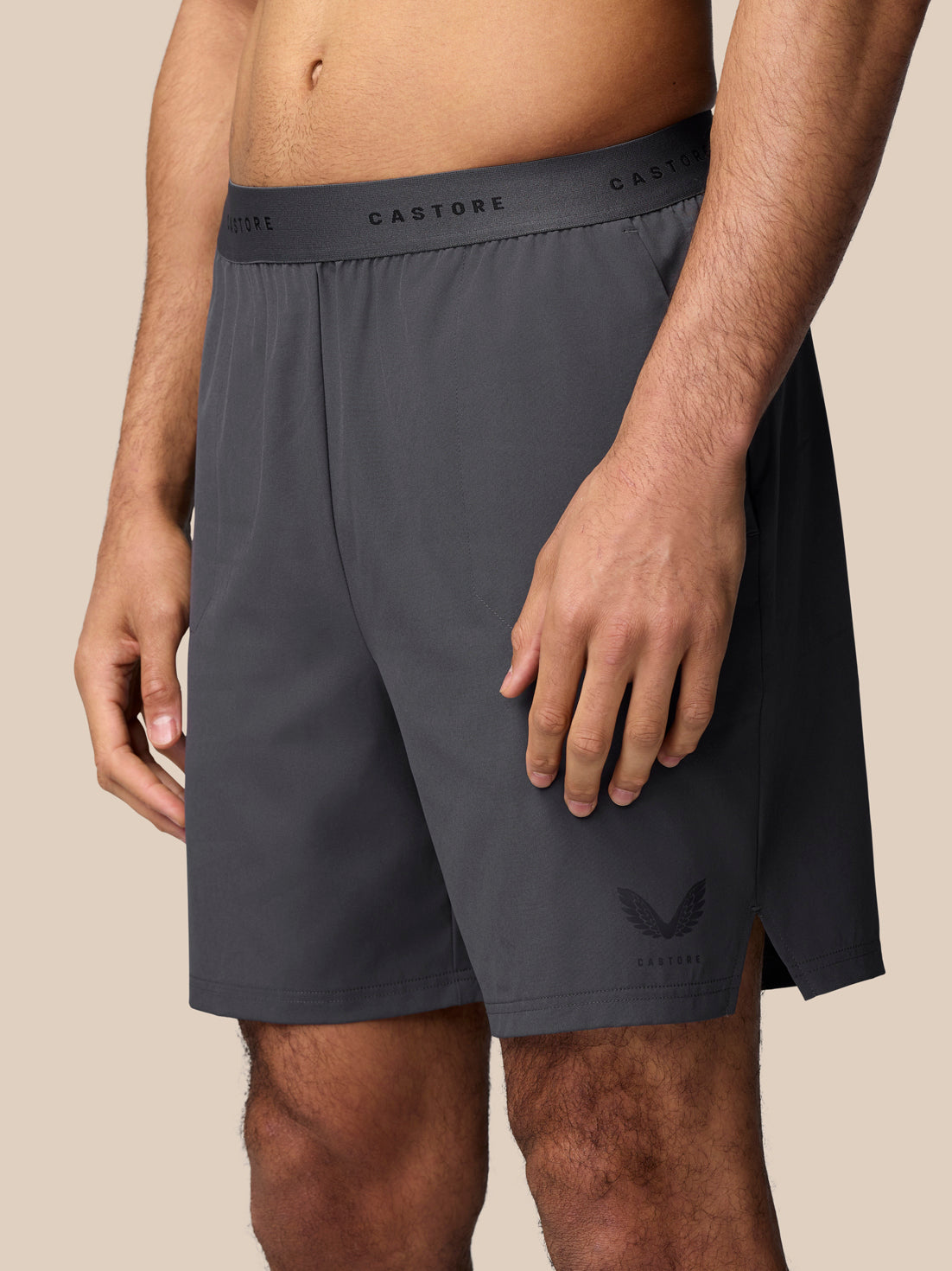 Gunmetal Adapt Training Shorts shown on a model with elastic waistband drawcord side pocket and Castore branding on the thigh.