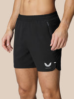Close-up of black Flow Training Shorts waist area showing elastic waistband and side zip pocket.