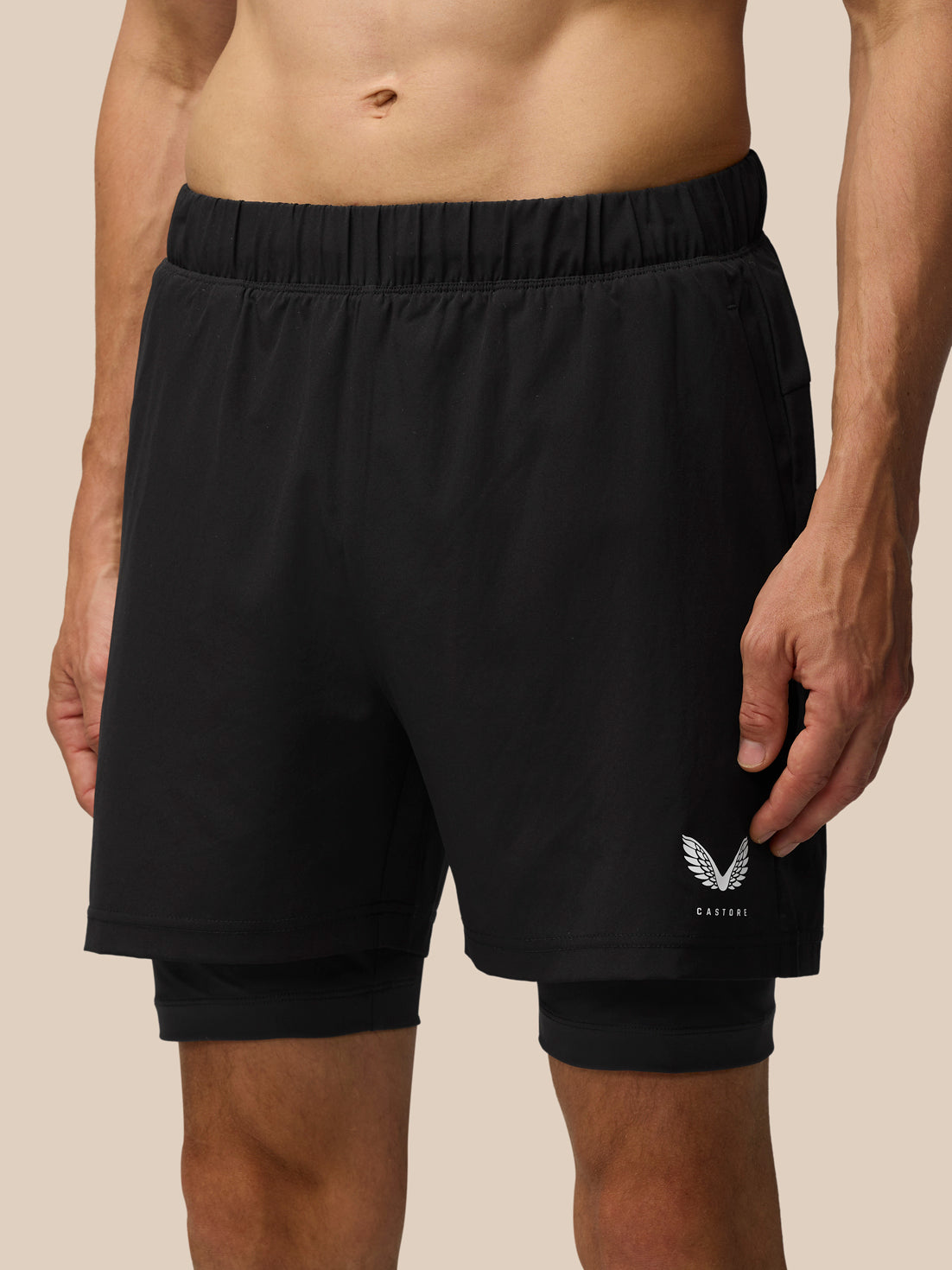Front view of black Flow 2-in-1 shorts with inner tight visible and Castore logo on the leg.