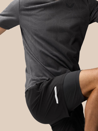 Back view of black Flow 2-in-1 shorts showing the side pocket with a Castore tag