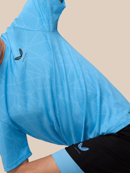 Close-up of Flow 2-in-1 shorts in black with a blue underlayer worn with a blue patterned top