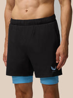 Black Flow 2-in-1 shorts with blue undershorts visible below and a blue pocket accent with the Castore logo