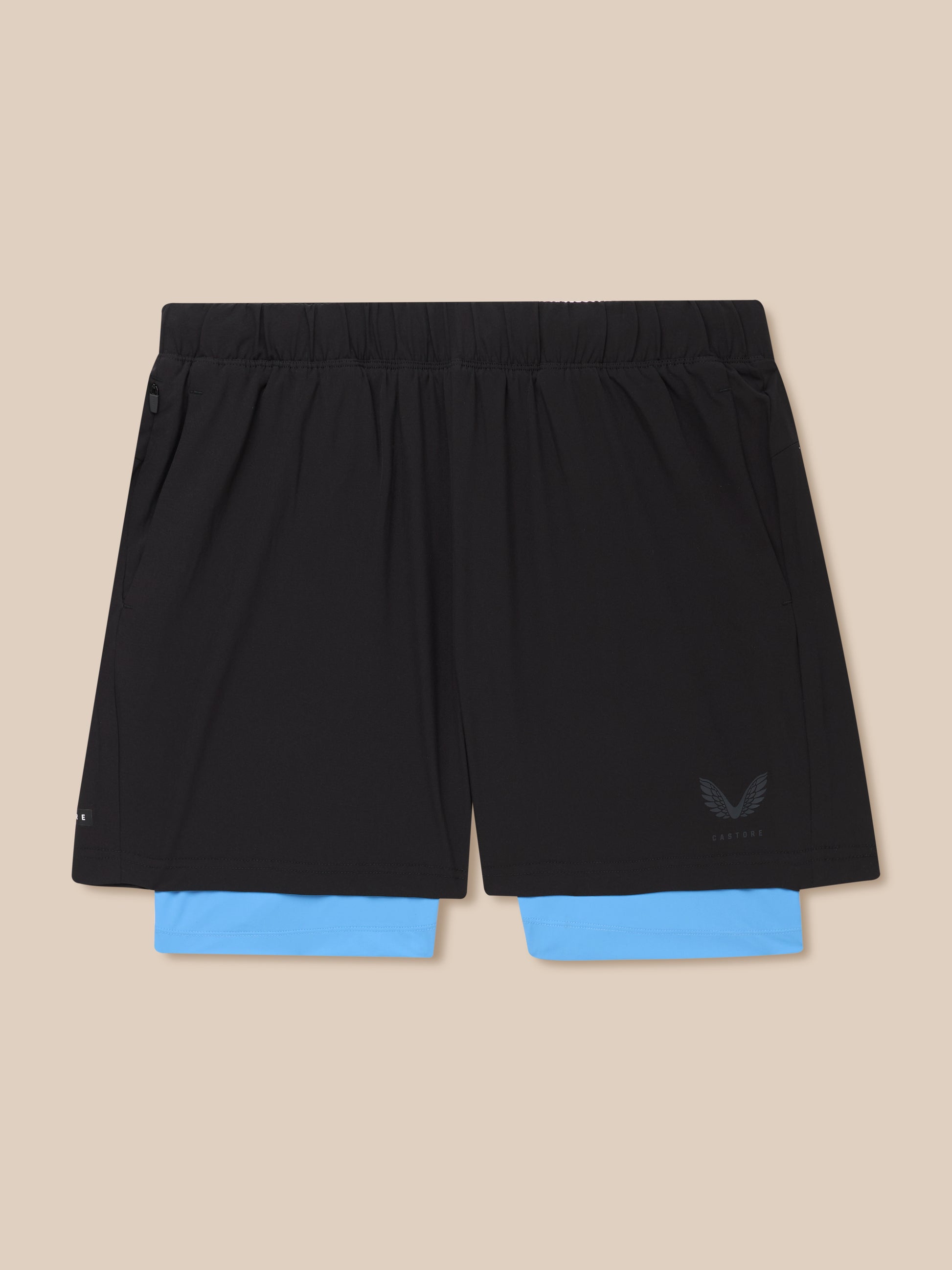 Waist area of Flow 2-in-1 shorts showing an elastic waistband with blue underlayer peeking out
