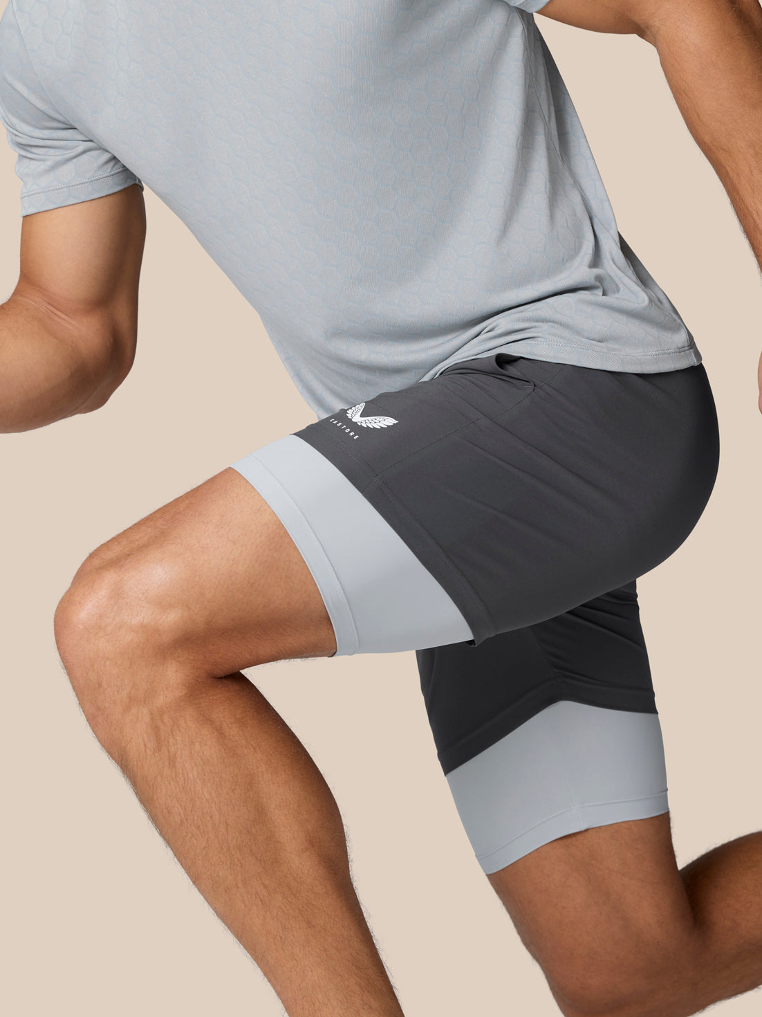 Flow Training 2-In-1 shorts in dark grey with light grey leg cuffs and Castore logo on right thigh