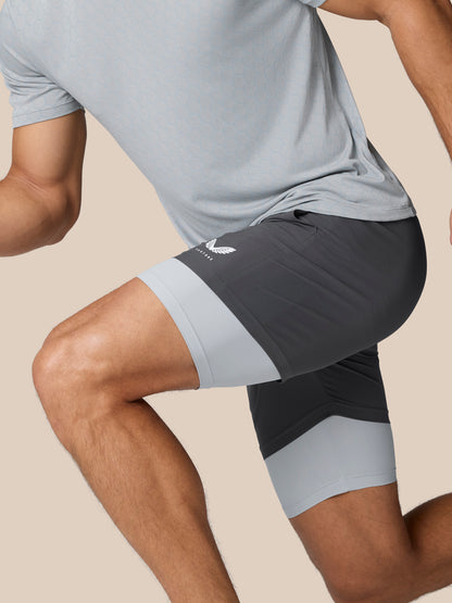 Flow Training 2-In-1 shorts in dark grey with light grey leg cuffs and Castore logo on right thigh