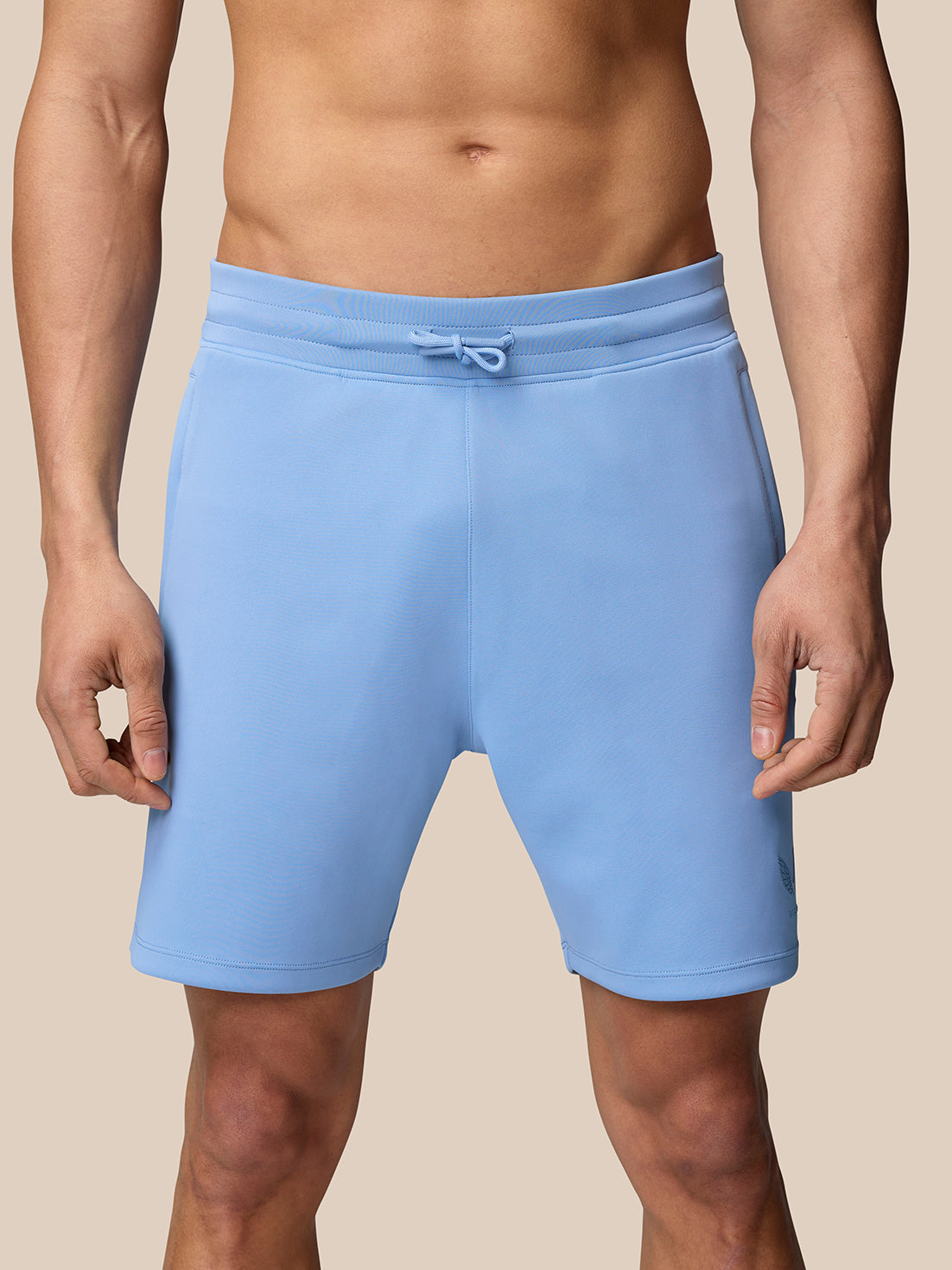 Man wearing sky blue Flex Shorts with drawstring waist and no side seams for a smooth, comfortable fit.