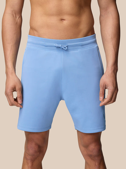 Man wearing sky blue Flex Shorts with drawstring waist and no side seams for a smooth, comfortable fit.