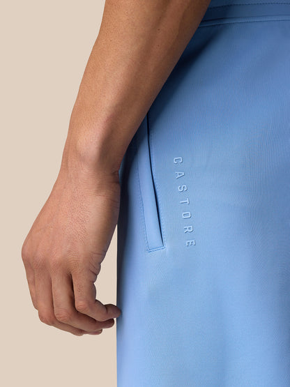 Close-up side view of sky blue Flex Shorts showing vertical Castore branding along the leg