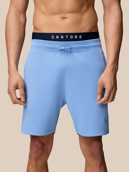 Male model wearing sky blue Flex Shorts with dark Castore waistband and drawstring