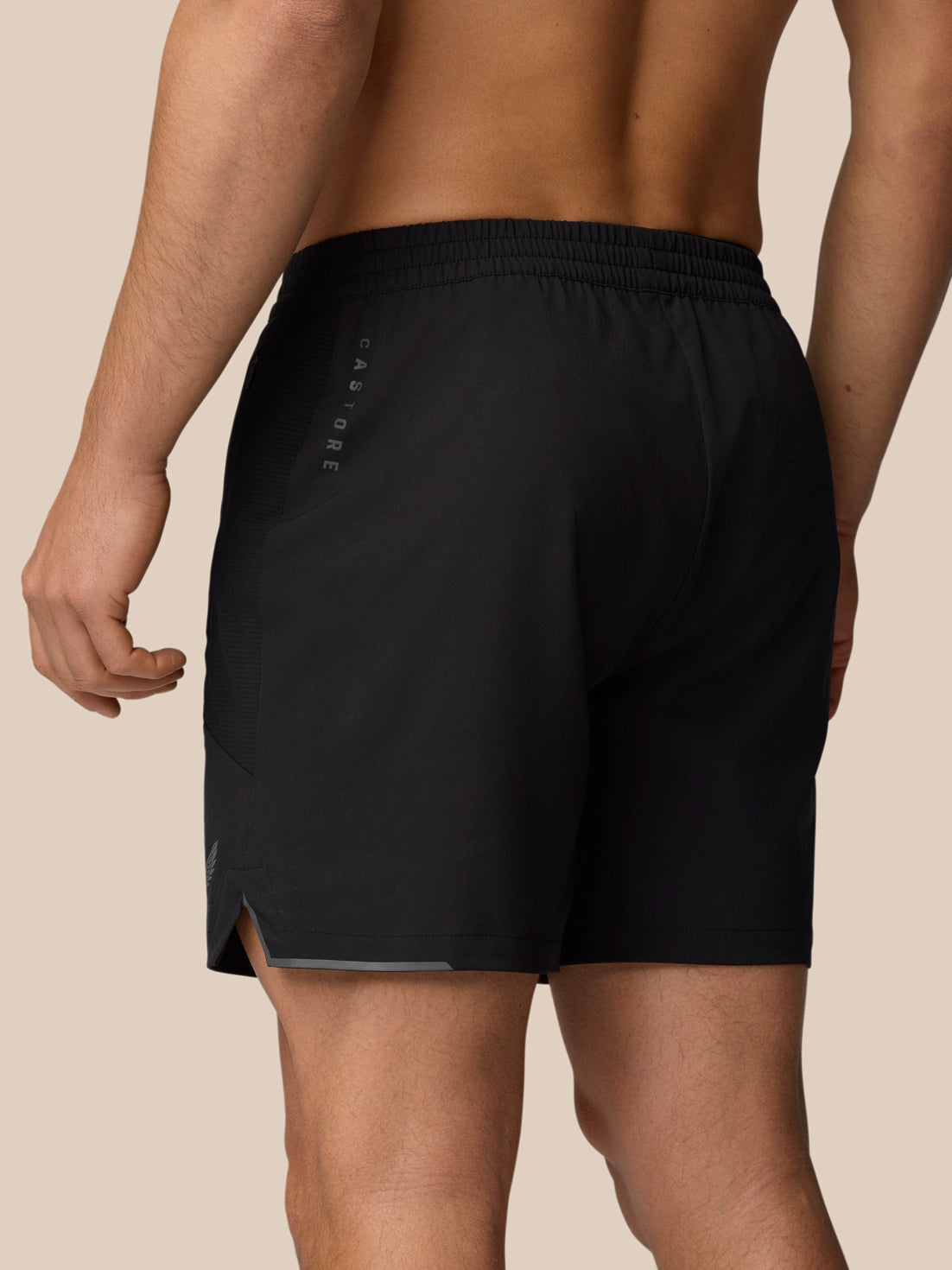 Back view of black Apex 6 inch training shorts with vertical Castore branding along the leg.