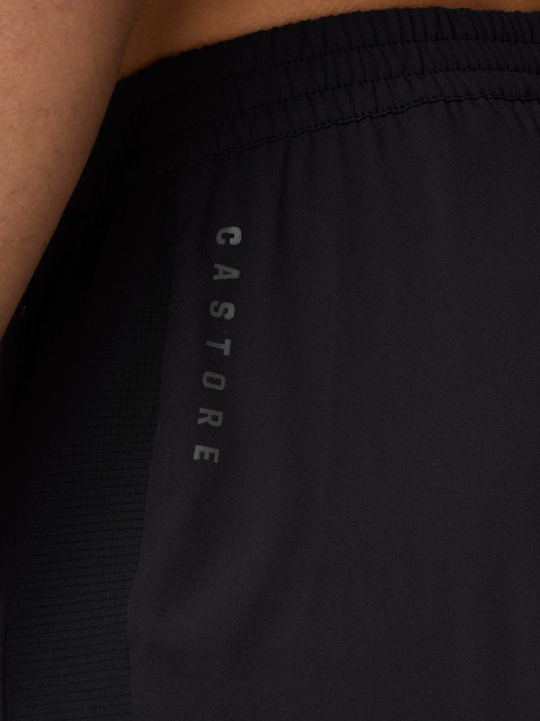 Close-up of the black Apex Training Shorts waistband showing vertical Castore branding.